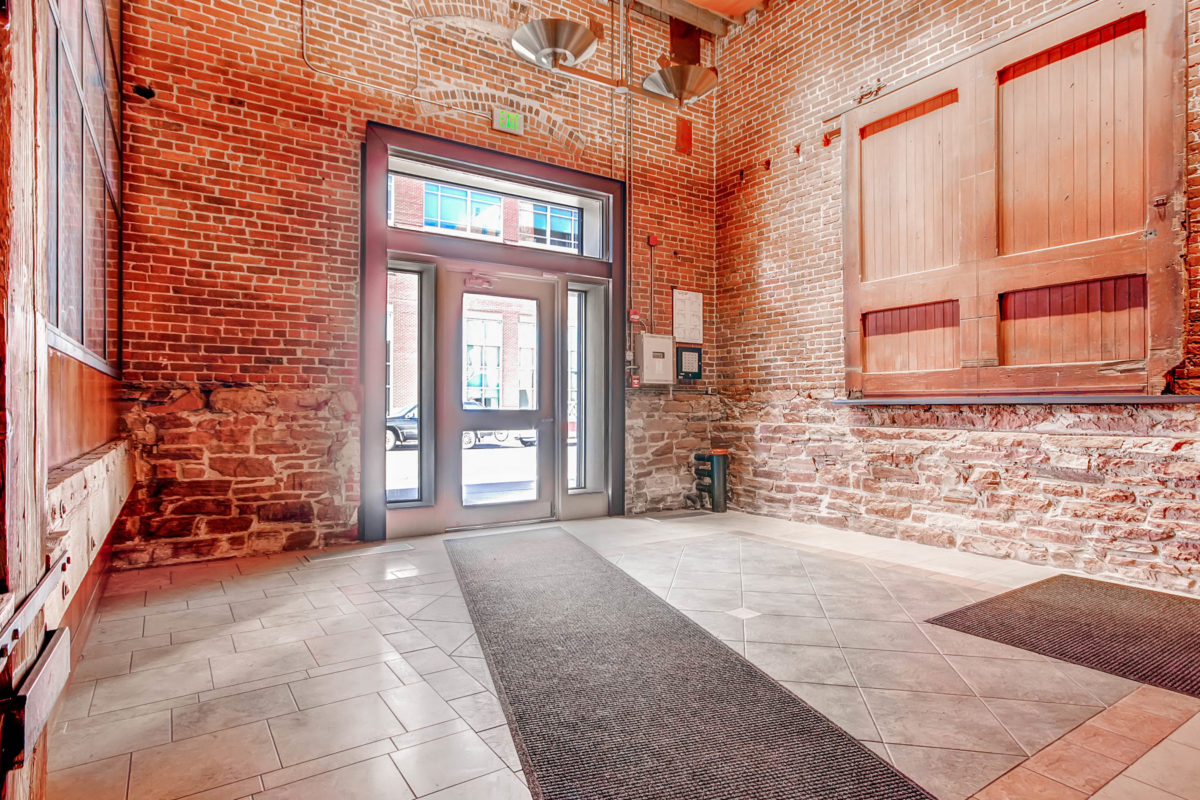 Interior of 1430 Wynkoop, a converted brick warehouse with exposed wood finishes.