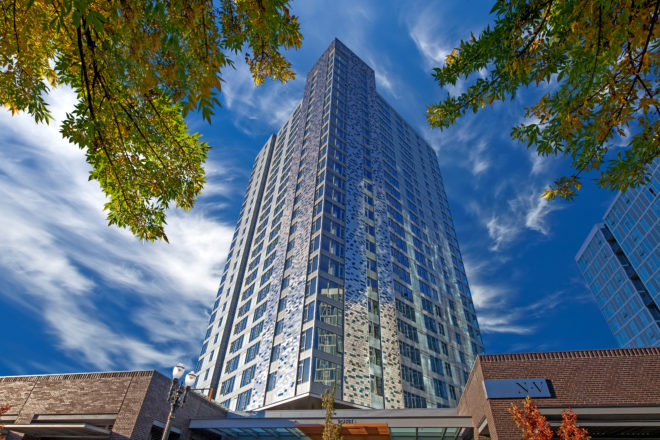NV is a 26-story luxury apartment building with a modern metallic finish.