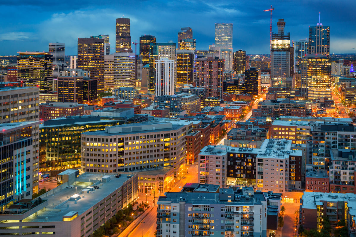 Denver's downtown streets and skyline lights up the dark sky