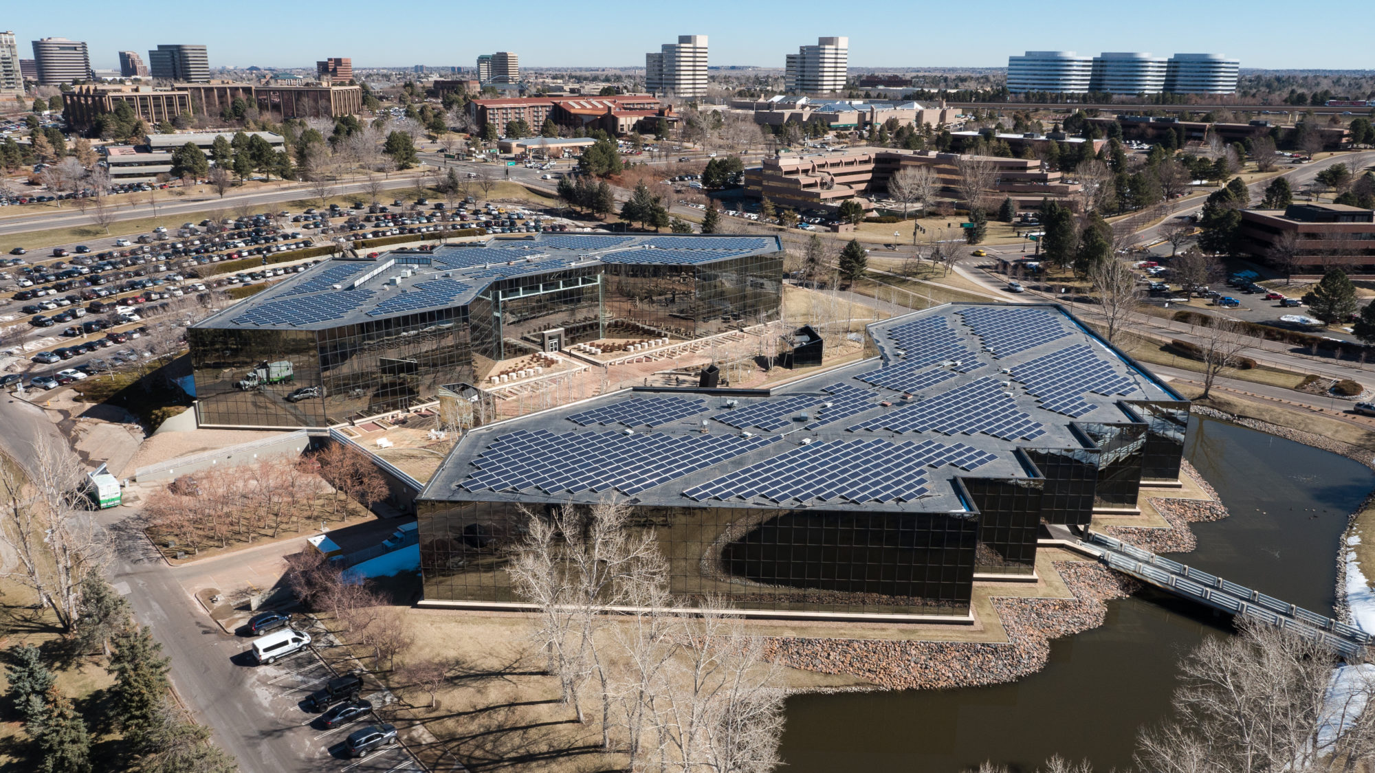 Aerial view of Harlequin Plaza in Denver, featuring a large solar panel installation on the roof.