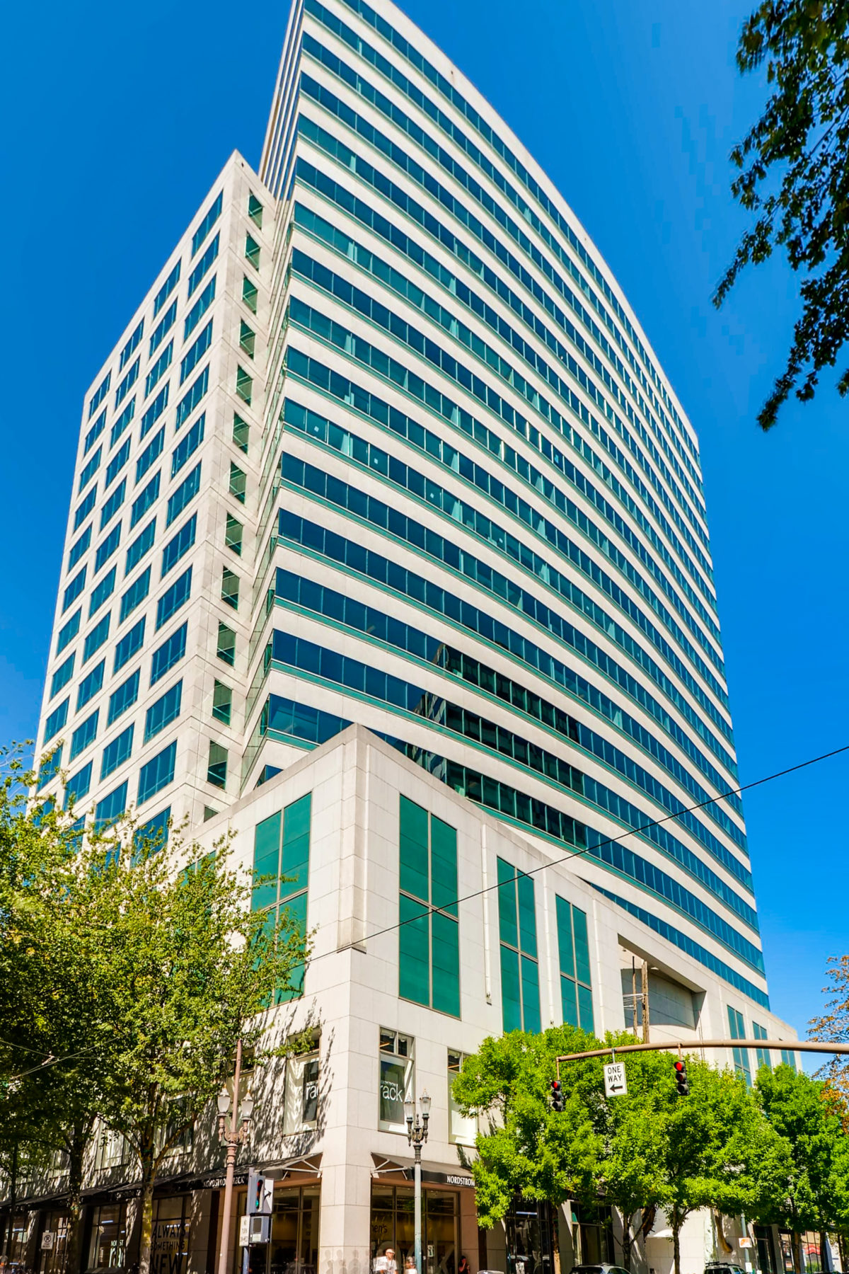 Moda Tower is Unico's latest acquisition in Portland. The 24-story skyline asset is prominently located in Portland's central business district (CBD). In the photograph, the MODA Tower rises above downtown against a cloudless blue sky.