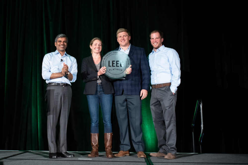 Unico Senior Manager of Sustainable Real Estate Edmée Knight and Swinerton's Senior Project Manager Adam Lulay and Assistant Project Manager Shelby Boardman with USGBC's Mahesh Ramanujam at the Rocky Mountain Green plenary. USGBC honored Unico's sustainability leadership at the region's largest sustainability conference in this photograph dated April 11, 2019.