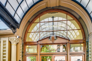 View of the entrance in this exterior photograph of the Colman Building, a historic City of Seattle landmark located in Seattle's Waterfront. The commercial real estate investment company Unico Properties acquired the asset in May 2019.